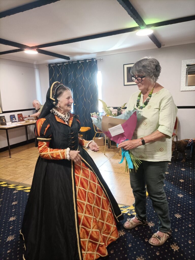 Newsletter editor Jan receives flowers for producing the u3a handbook.