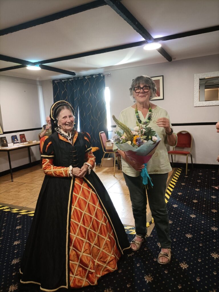 Newsletter editor Jan receives flowers for producing the u3a handbook.